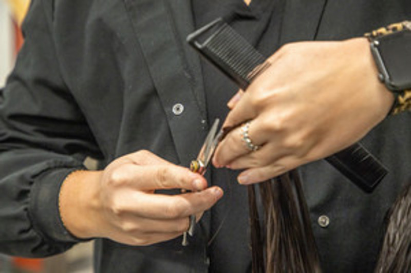 Stylist trimming hair